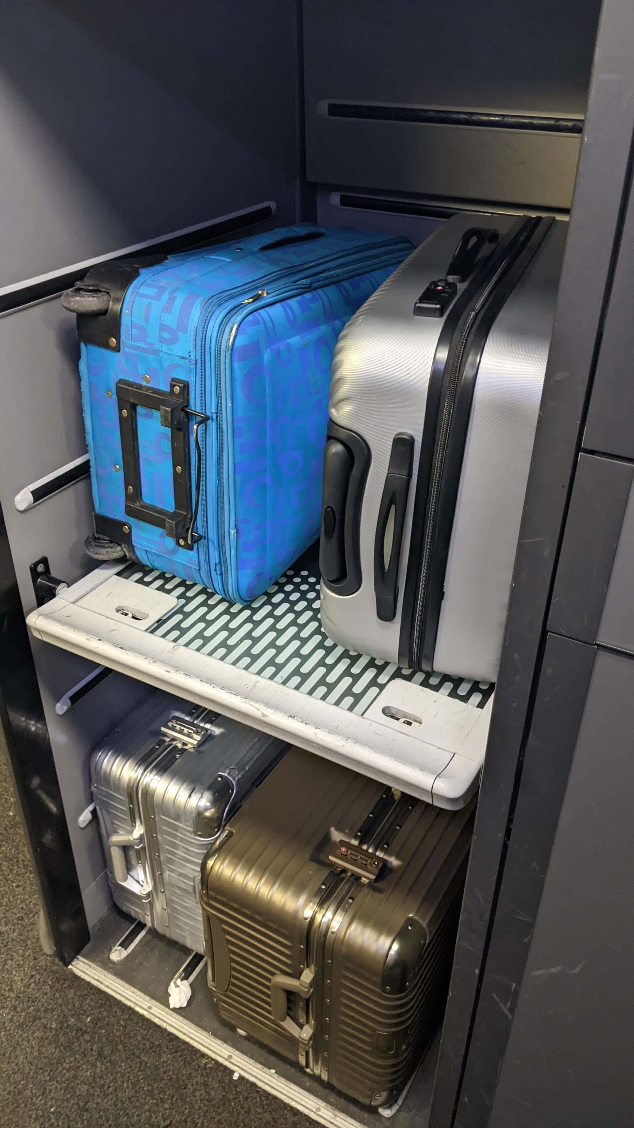 Baggage storage racks on a Eurostar train; four large suitcases, two on each rack